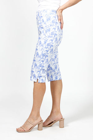 Holland Ave Julia Abstract Floral Pedal Pusher. Periwinkle abstract floral print on a white background. Pull on pant with hidden elastic waistband and faux fly. Snug through stomach and hip slim through leg. 17" inseam._34995723665608