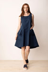LIVy Habitat Sculpt Artist Dress in Navy. Textured jacquard dot parachute fabric. Sleeveless scoop neck dress with fitted bodice and flared skirt. High low hem. 2 large pouf pockets in front. Zip back. Relaxed fit._t_35020777259208