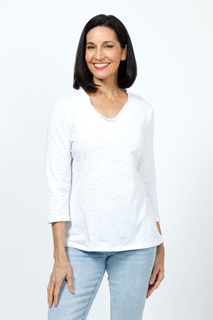 Top Ligne Ruffle Trim Tee in White. Slub cotton v neck 3/4 sleeve tee with ruffle trim at neckline. Relaxed fit._35202203451592