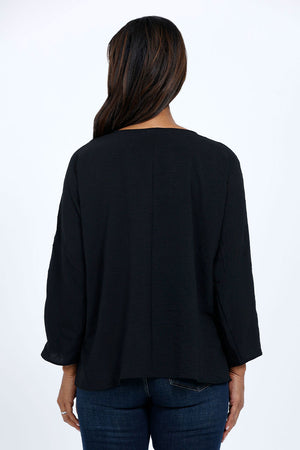 Top Ligne Dolman Roll Tab Top in Black. Gently crinkled fabric. V neck with center front pleat. Dolman 3/4 sleeve with roll button tab cuff. A line shape. Relaxed fit._34767644229832