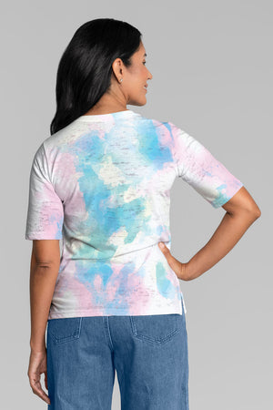 Whimsy Rose Aurora Elbow Sleeve Tee in White Multi. Tie dye effect in soft pastels on a white background. v neck elbow sleeve tee. Burnout fabric with sublimation printing. A line shape. Side slits. Relaxed fit._34899968262344