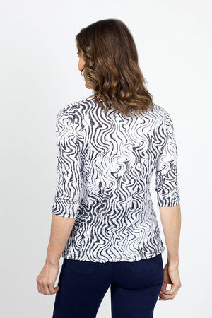 Top Ligne Squiggles Grommets Top in Black & White. Op art squiggle print in black on a white background. V neck 3/4 sleeve top with grommets and lace-up detail at left front hem. Relaxed fit._35010878308552