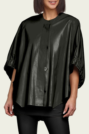 Planet Ms Maisel Vegan Leather Jacket in Black. Crew neck button down oversized jacket with covered button placket. Elbow length dolman sleeve with ruched hem cuff. High low hem. Oversized fit. One size fits many._34818368176328