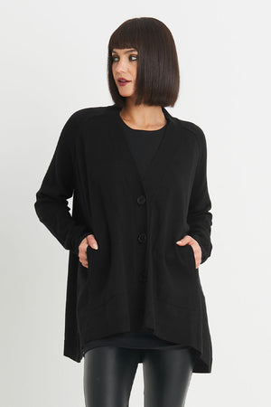 Planet Varsity Cardigan in Black.  V neck oversized swing cardigan with 2 front patch pockets.  Long sleeves.  Rib trim at neck hem and cuff.  One size fits many._34276441522376