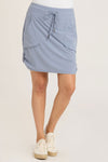 Wearables Jett Skort in Vault, a sky blue.  Drawstring waist skirt with front pouch pockets and snap tab detail at side hem.  Attached short.  Skirt has 19" inseam: short: 3"_t_35196268314824