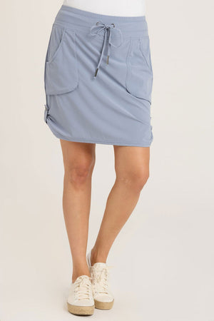 Wearables Jett Skort in Vault, a sky blue.  Drawstring waist skirt with front pouch pockets and snap tab detail at side hem.  Attached short.  Skirt has 19" inseam: short: 3"_35196268314824