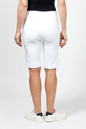 Holland Ave Bermuda Short in White. 2 1/2" waistband with 2 front slash pockets. 11" inseam. Snug through stomach and hip, slim to hem._34995042320584