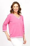 Metric Stripe Border Sweater in Rose. White double stripe at neck, cuff and hem. V neck, 3/4 sleeve sweater. Open weave knit down center of arm. Relaxed fit._t_35066090291400