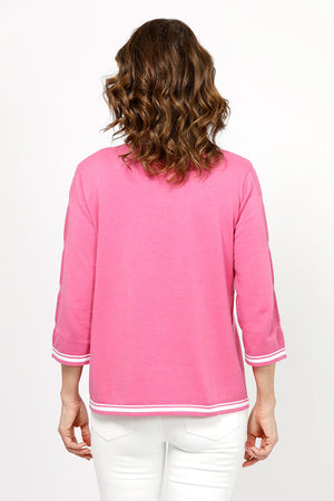 Metric Stripe Border Sweater in Rose. White double stripe at neck, cuff and hem. V neck, 3/4 sleeve sweater. Open weave knit down center of arm. Relaxed fit._35066090127560