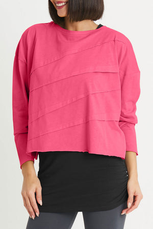Planet Mini Tucked T in Lipstick Pink, a deep magenta.. Crew neck cropped oversized tee with diagonal tuck pleats on front and back. Long sleeves. Oversized fit._34277785567432