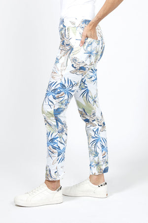 Organic Rags Banana Leaf Pant in White with blue and green banana leaf print. Elastic waistband with 2 slash pockets. Crinkle fabric. 28" unrolled._34960566419656