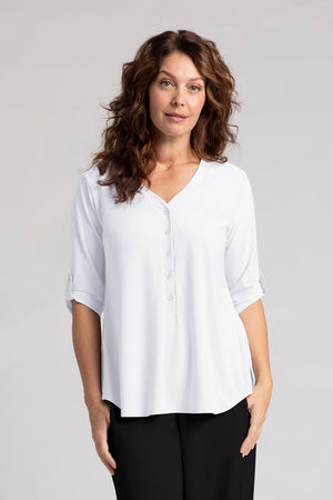 Sympli Convoy Henley in White. V neck with 5 button placket. 3/4 sleeve with button tab closure in satin crepe. Back yoke with inverted pleat below. Curved hem. Side slits. Relaxed fit._35065506234568