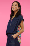 Zaket & Plover Confetti Blouse in Denim with bright multi print.  Mixed media, henley-style top.  Pointed collar with printed 6 button placket.  Banded cap sleeve.  Back yoke in denim with printed fabric below.  Shirt tail hem.  Relaxed fit._t_34998176973000