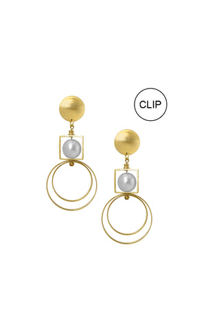 Modern and chic pair of clip-on drop earrings each showcasing a luminous gray pearl inside a golden square framed on top of two different sized open golden rings dangling from a large flat golden circle stud with standard hypoallergenic earring clip._33842281054408