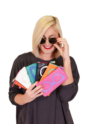 Blonde woman wearing sunglasses looking a different colored eyeglass cases_8680996700258