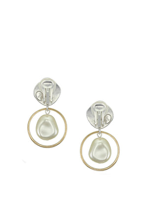 Stylish and modern dangle earrings each featuring a luminous white pearl framed by a golden brass ring hanging from a hammer textured organic shaped silver stud with a  standard hypoallergenic earring clip backing._33891613212872