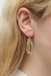 Modern and stylish earrings each featuring a lightly hammered golden rectangle linked with a smooth interlocking silver colored hoop dangling from a standard hypoallergenic earring hook._t_33354237870280