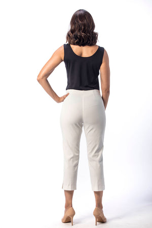 Holland Ave Susan Denim Crop Pant in White. Pull on hidden waistband pant with faux zipper flap. Snug through hip falls straight to hem. Side slits. 25" inseam._13297494917229
