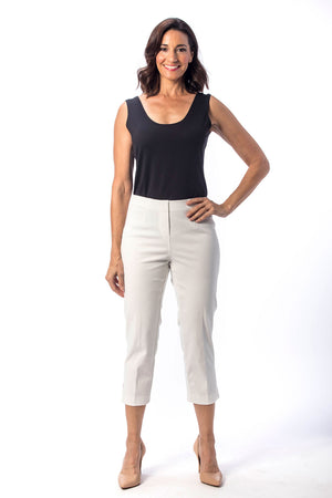 Holland Ave Susan Denim Crop Pant in White. Pull on hidden waistband pant with faux zipper flap. Snug through hip falls straight to hem. Side slits. 25" inseam._13297494949997