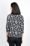 Lolo Luxe Sherri Cow Print Top in Black with white spots. V neck 3/4 sleeve top with high low hem. Relaxed fit._t_34943413223624