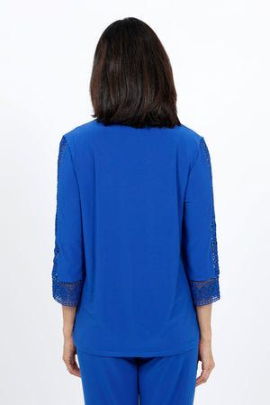Ours Barbie Crochet Sleeve Top in Royal. Banded crew neck with 3/4 sleeve. Crochet lace inset down center of sleeve. Crochet lace cuff. A line shape. Relaxed fit._34656862175432
