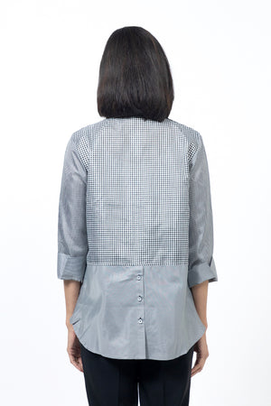 Beau Chemise Checked Bedford Blouse in Black and White. Mixed check blouse. Pointed collar button down blouse. 3/4 sleeves with turn back cuff lined in smaller check. Single bias check patch pocket at breast. Back yoke. Back bias check insert at hem with center button detail. Relaxed fit._34519321968840