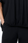 O.U.R.S. Stacey Ruched Front Top in Black. Crew neck dolman short sleeve top. Center front inset panel is softly gathered at the neckline and ruched at the hem. Inverted "U-shaped" hem. Plain back. Relaxed fit._t_34815862407368