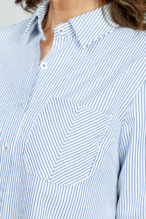 Cali Girls Stripe Blouse with Herringbone Pocket in Denim/White.  Narrow blue vertical stripe on a white background.   Pointed collar button down with 3/4 sleeve. Split cuff.  Shirt tail hem.  Single diagonal stripe breast pocket.  Relaxed fit._52875953242478