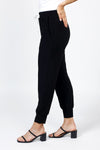 Organic Rags Stephie Jogger in Black. Drawstring waist pull on pant with 2 front slash pockets. Cuffed bottom. White drawstring. Poly/jersey fabric. 29" inseam._t_35298336866504
