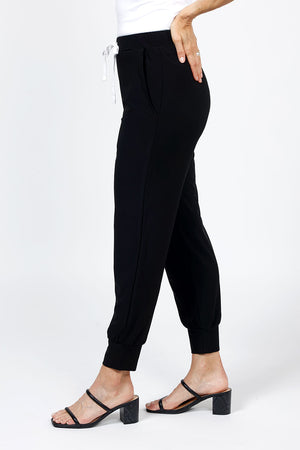 Organic Rags Stephie Jogger in Black. Drawstring waist pull on pant with 2 front slash pockets. Cuffed bottom. White drawstring. Poly/jersey fabric. 29" inseam._35298336866504