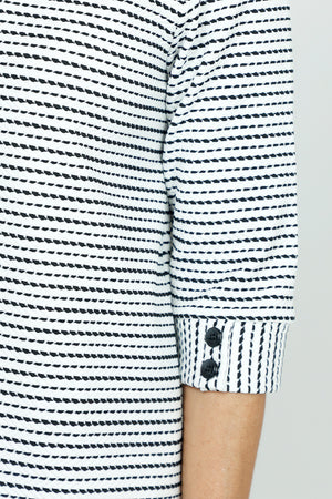 Top Ligne Button Cuff Stitch Stripe in Black/White.  Broken stripes in Black on a white background. Stand collar with v placket.  3/4 sleeve with 2 buttons at cuff.  Curved hem.  Relaxed fit._53001369485678
