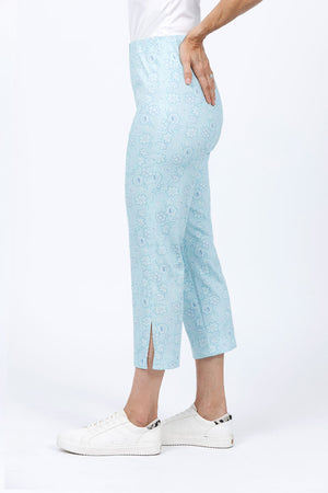 Holland Ave Susan Dotted Flowers Crop in Aqua. Tonal dotted flower print. Pull on pant with hidden elastic waist and faux fly placket. Snug through hip and thigh falls straight to hem. 24" inseam._34811687305416