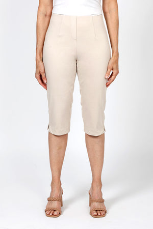 Holland Ave Julia Denim Pedal Pusher in Khaki. Pull on pant with elastic hidden waist and faux zipper pocket. Slim through leg. Side slits. 17" inseam._36030721130696