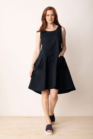 LIV by Habitat Sculpt Artist Dress in Black.  Textured jacquard dot parachute fabric.  Sleeveless scoop neck dress with fitted bodice and flared skirt.  High low hem.  2 large pouf pockets in front.  Zip back.  Relaxed fit._35020777193672