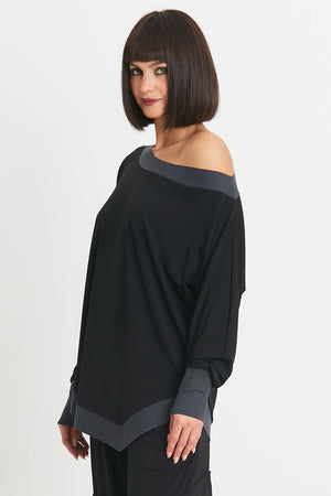 Planet Matte Jersey Boat Neck Top in Black with Obsidian gray trim at neckline, cuff and hem. Boat neck with long sleeves and cinched cuff. Asymmetric pointed hem in front. Slightly curved hem in back. Oversized fit. One size fits many._34273174618312