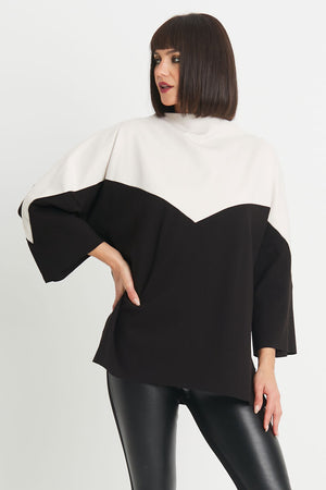 Planet Scuba Chevron Top in Black/Vanilla.  2 tone top with rolled funnel neck and dolman 3/4 sleeve.  Colors are separated top to bottom in a chevron pattern.  Oversized fit.  Swing shape.  One size fits most._34304457834696