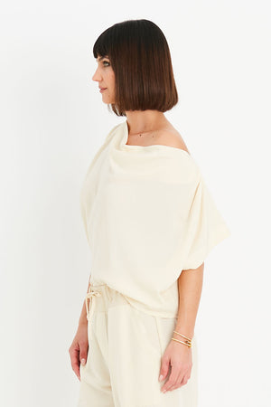 Planet Peachskin Top in Butter. Boatneck dolman short sleeve top. Off the shoulder. Boxy shape. Side slits. One size fits many._34903032070344