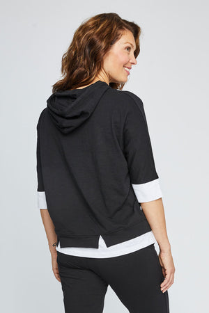 Neon Buddha Dolman Top in Black. Crew neck dolman elbow sleeve top. Colorblock inserts at neck and hem. Front contour seams with contrast piping. Front inseam pockets with button detail. Attached hood with contrast drawstrings. Relaxed fit._35324927312072
