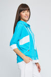 Neon Buddha Dolman Top in Gulf blue. Crew neck dolman elbow sleeve top. Colorblock inserts at neck and hem. Front contour seams with contrast piping. Front inseam pockets with button detail. Attached hood with contrast drawstrings. Relaxed fit._t_35324926722248