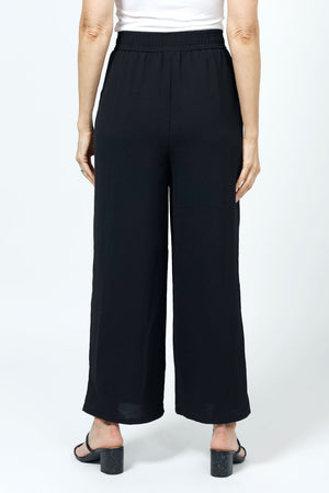 Top LIgne Relaxed Wide Leg Pant in Black. Lightly textured fabric. 2" elastic waistband with 2 front slash pockets. Wide draped leg. 12" wide at leg opening; 26" inseam._35194735263944