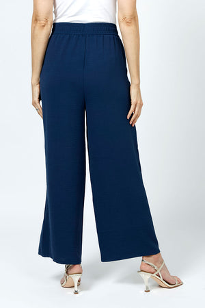 Top LIgne Relaxed Wide Leg Pant in Navy. Lightly textured fabric. 2" elastic waistband with 2 front slash pockets. Wide draped leg. 12" wide at leg opening; 26" inseam._35194735329480