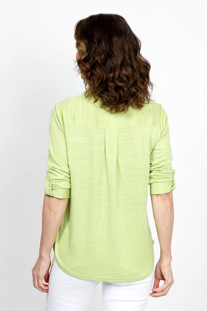 Top Ligne 2 Pocket Button Down Top in Lime. Textured fabric. Pointed collar with split v neck button down. 3/4 sleeve with button tab closure. 2 front chest patch pockets. Shirt tail hem. Relaxed fit._35439000289480