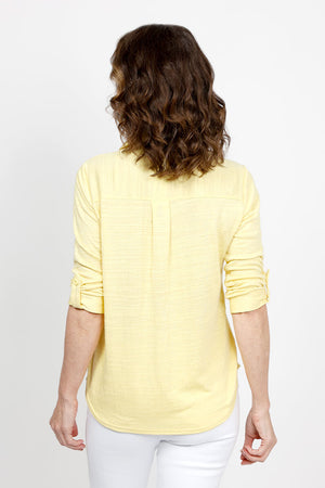 Top Ligne 2 Pocket Button Down Top in Lemon. Textured fabric. Pointed collar with split v neck button down. 3/4 sleeve with button tab closure. 2 front chest patch pockets. Shirt tail hem. Relaxed fit._35438999863496
