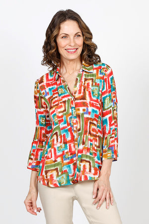 Cali Girls Geometric Pleated Bell Sleeve Blouse. Bright geometric print. Pointed collar v neck button down blouse. Long sleeves. Vertical pleats through body and sleeve. Relaxed fit._35537539072200