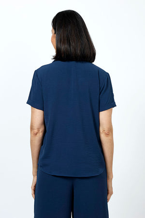 Top Ligne Collared Popover in Navy. Lightweight finely textured top. Pointed collar with open v placket. Short sleeves with sewn cuffs. Loose pleat in front. Curved hem. Relaxed fit._35201961459912