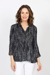 Cali Girls Tiny Dots Pleated Bell Sleeve Blouse in Black with tiny white dots print. Pointed collar v neck button down. Vertical pleating through body. Long pleated bell sleeves. Relaxed fit._t_35537565778120