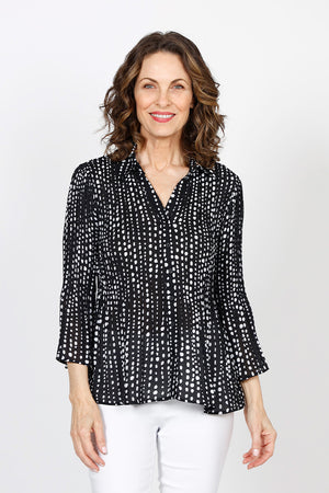 Cali Girls Tiny Dots Pleated Bell Sleeve Blouse in Black with tiny white dots print. Pointed collar v neck button down. Vertical pleating through body. Long pleated bell sleeves. Relaxed fit._35537565778120
