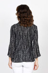 Cali Girls Tiny Dots Pleated Bell Sleeve Blouse in Black with tiny white dots print. Pointed collar v neck button down. Vertical pleating through body. Long pleated bell sleeves. Relaxed fit._t_35537565745352