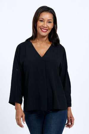 Top Ligne Dolman Roll Tab Top in Black. Gently crinkled fabric. V neck with center front pleat. Dolman 3/4 sleeve with roll button tab cuff. A line shape. Relaxed fit._34767644131528