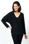 Ten Oh 8 Metallic V Neck Dolman in Black. V neck long sleeve dolman sleeve knit. Knit side to side to create ribbing. Rib trim at neck hem and cuff. Lurex thread adds metallic glow. Relaxed fit._t_34654382653640